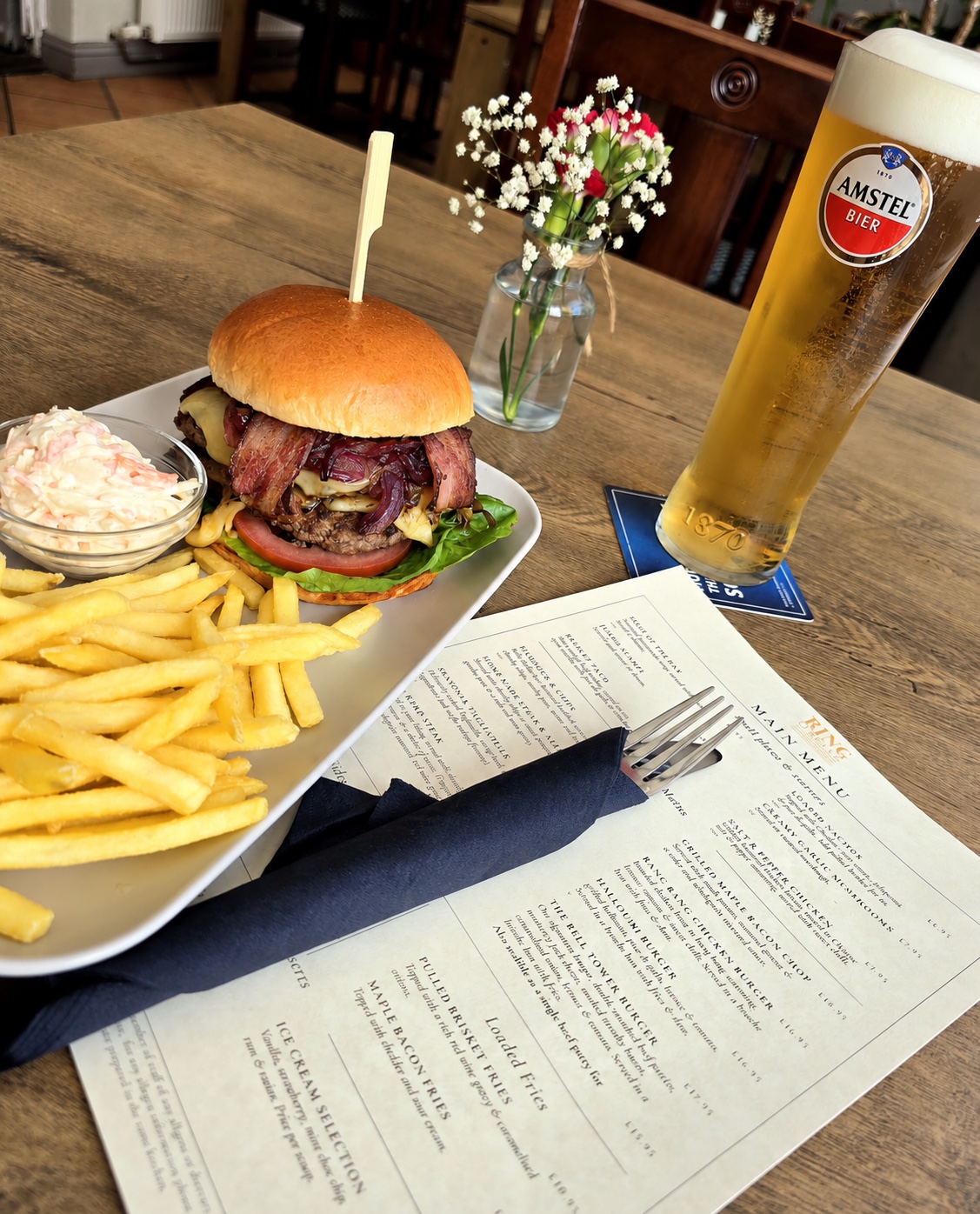 Bacon cheeseburger served with chips and coleslaw